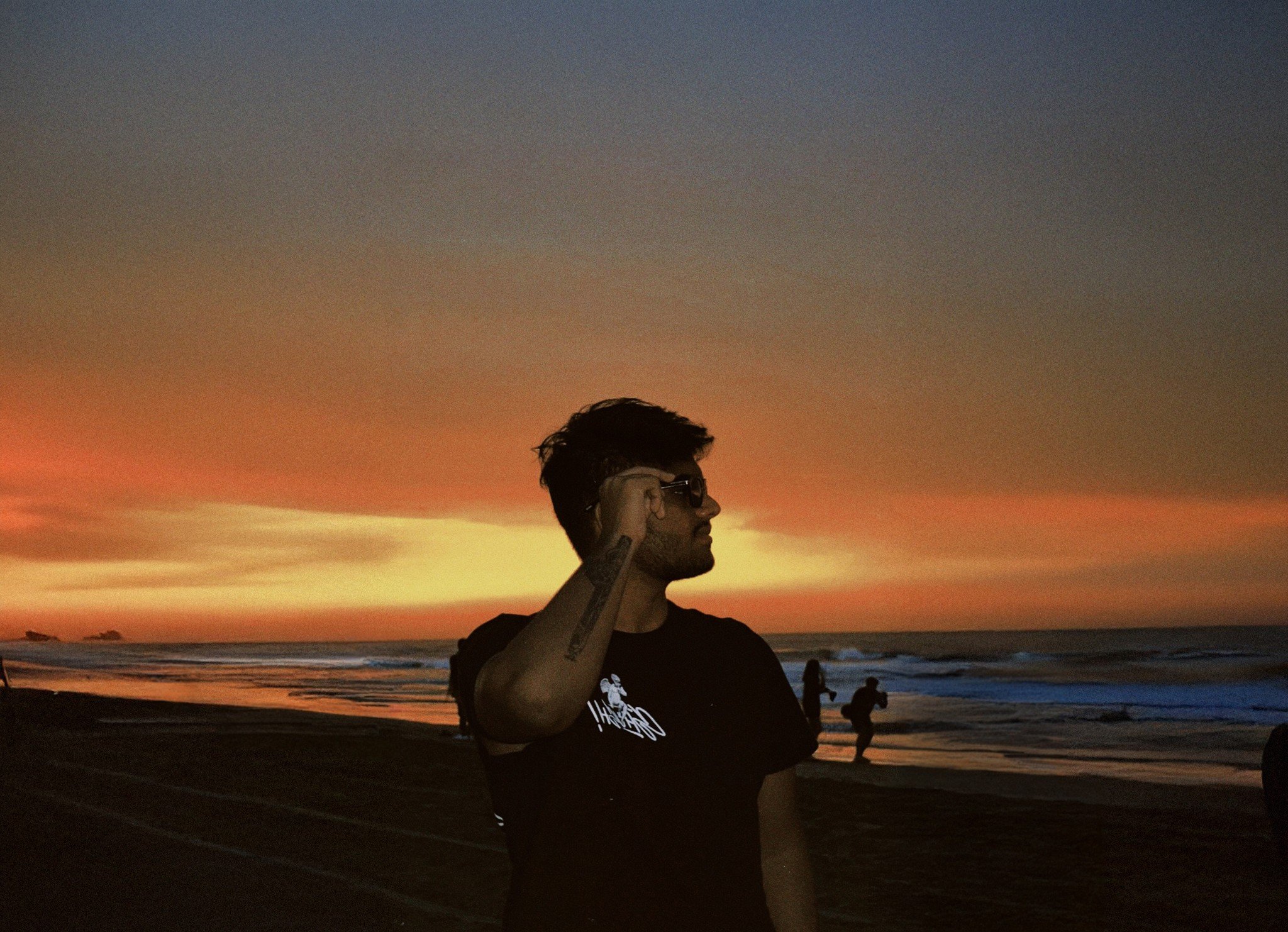 Aryan on a beach at sunset